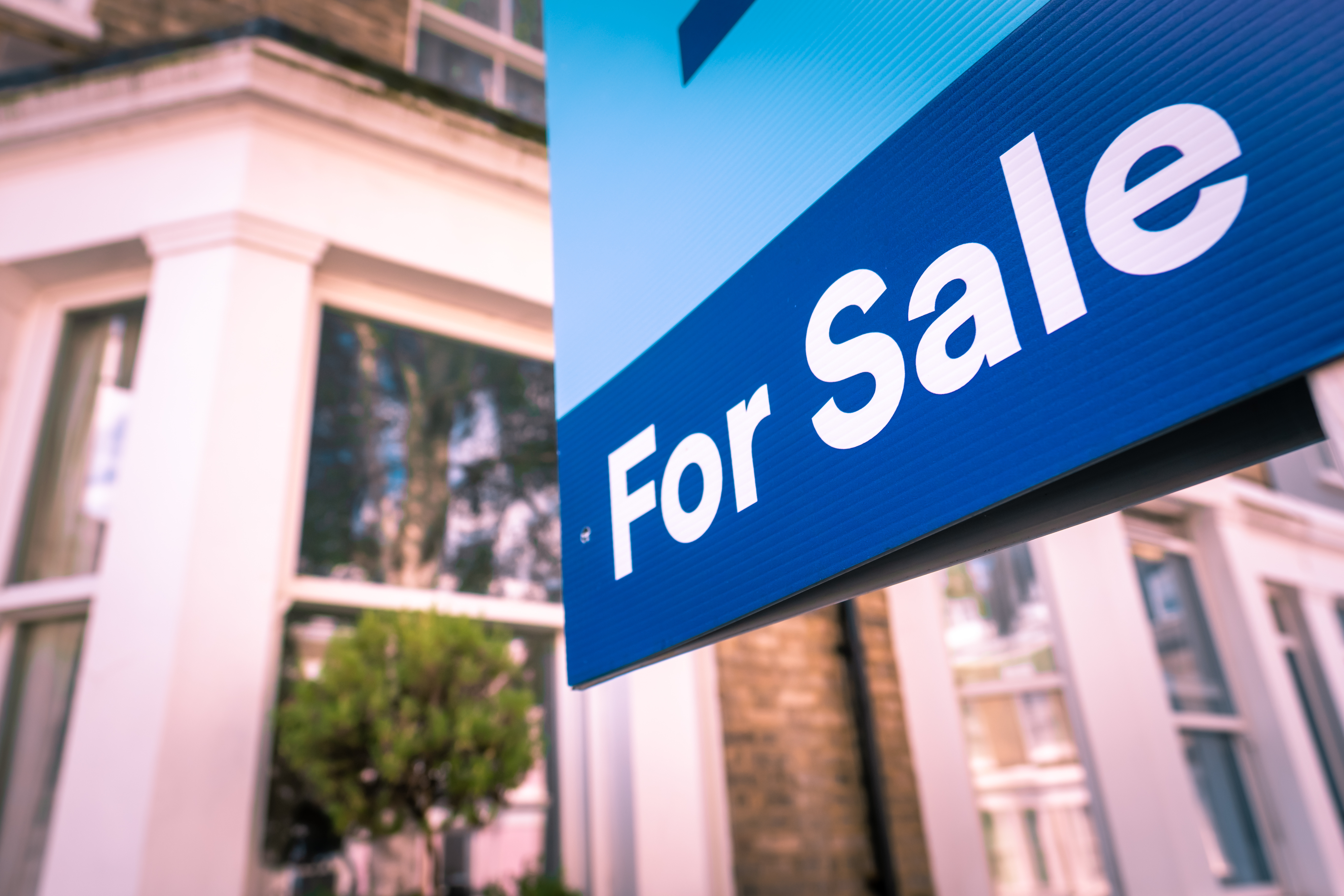 Property for sale sign outside a house
